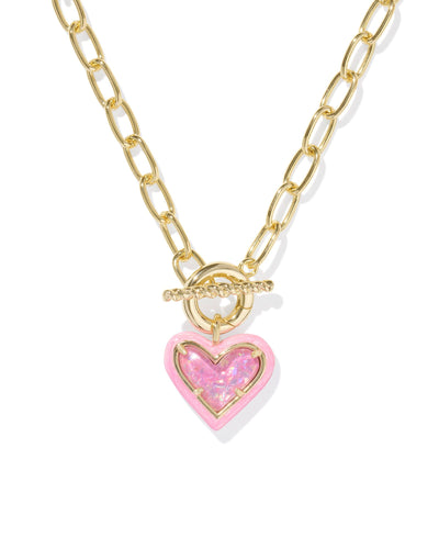 Gold link chain necklace with pink enamel framed pink iridescent glitter glass heart pendant, closeup.