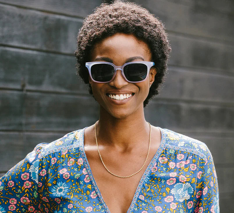 Golden Hour Sunglasses Readers in purple/floral on model, front view.