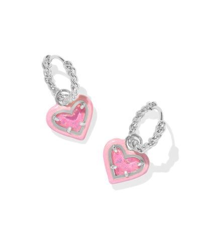 Twisted silver huggie hoops with pink enamel framed iridescent pink glitter heart pendant.