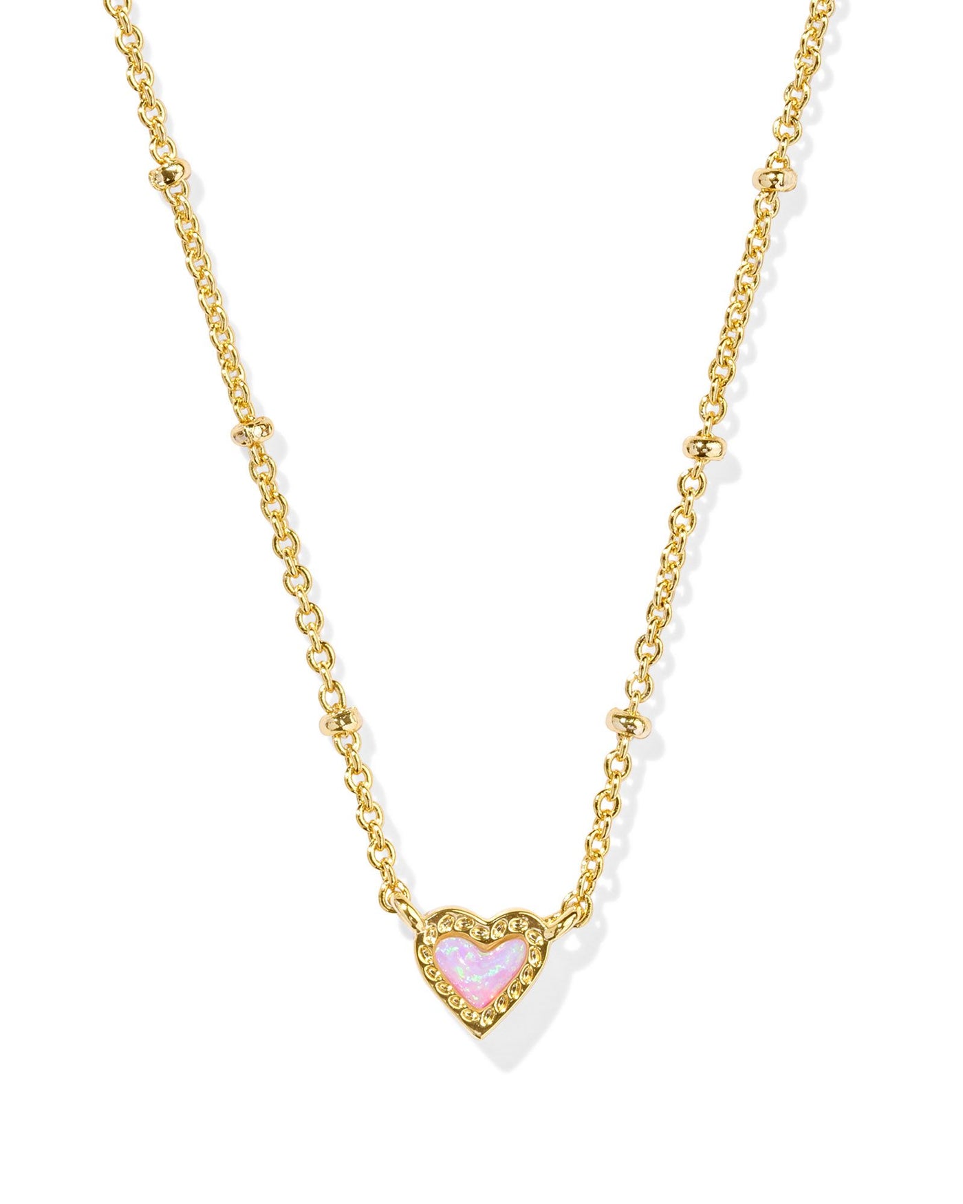 Gold satellite necklace with pink kyocera opal heart pendant, closeup.