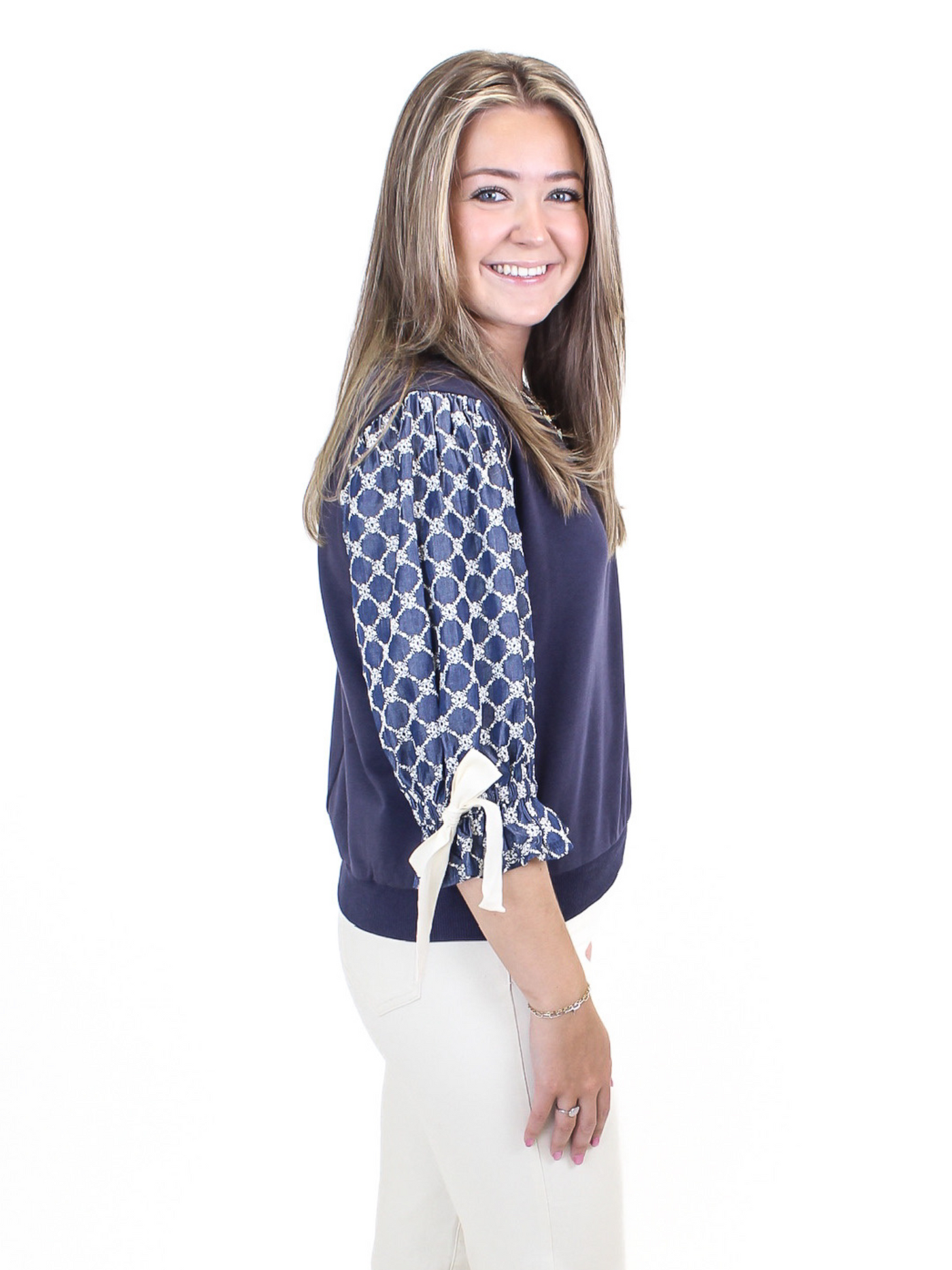 Eyelet Bow Sleeve Top - Navy side view.