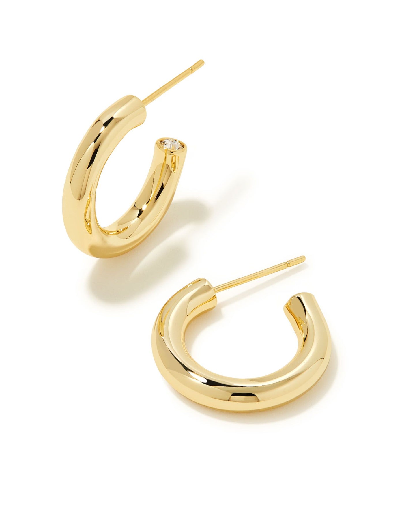 Kendra Scott Colette Huggie Earrings in Gold on white background, front view.