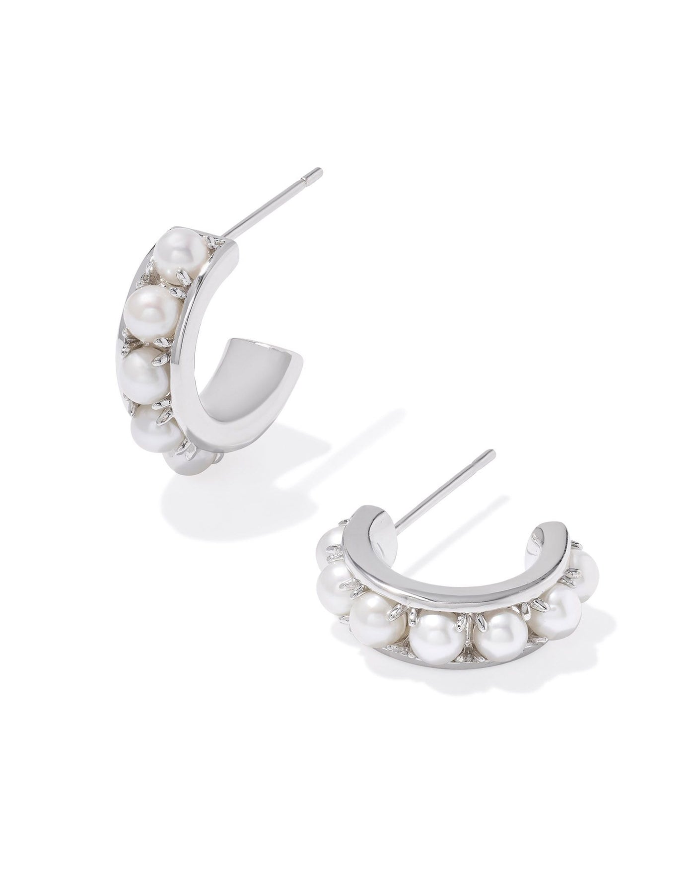 White pearl studded silver huggie hoops.