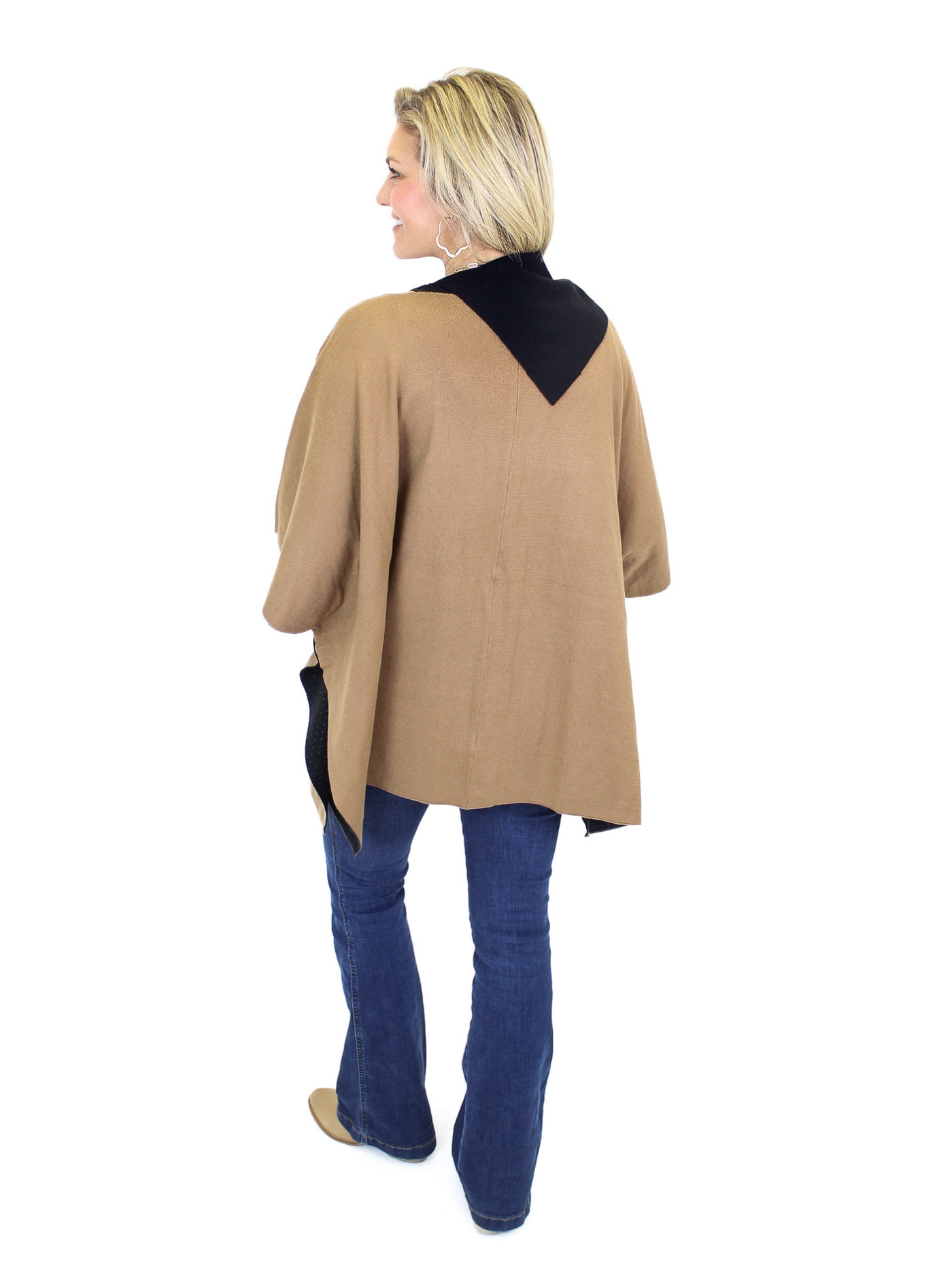 Black and tan poncho with gold buttons on model, full back view.