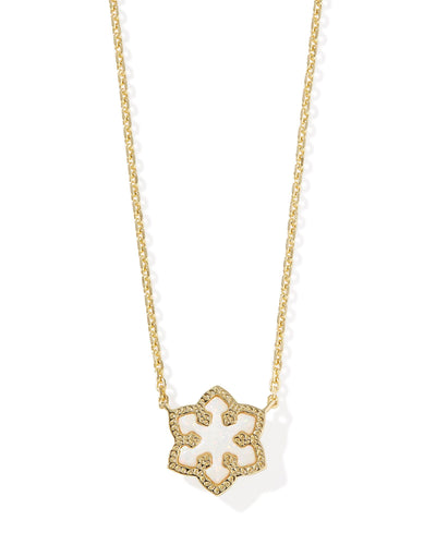 Gold necklace with gold framed white kyocera opal snowflake pendant, closeup front view.