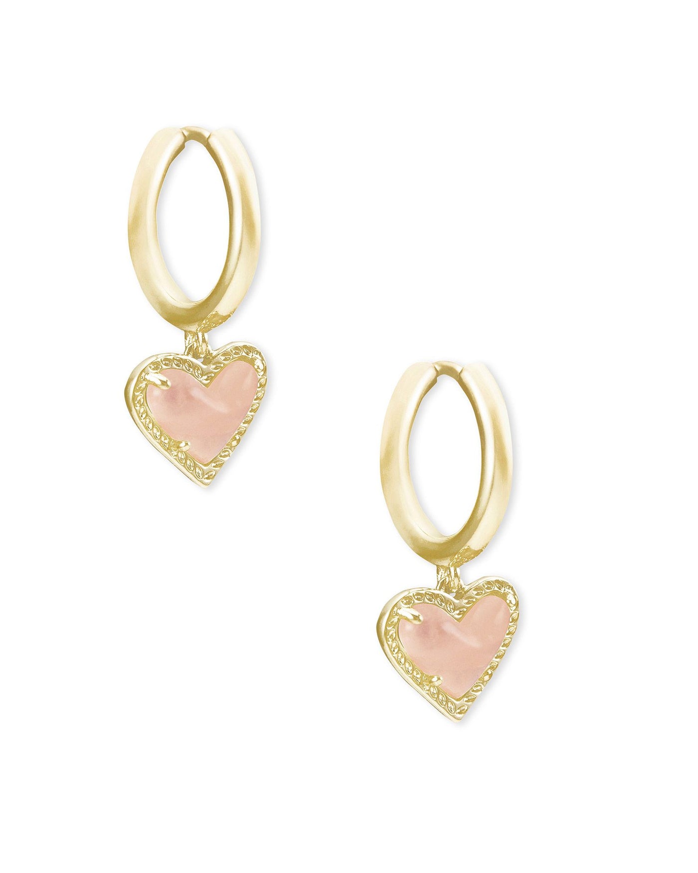 Kendra Scott Ari Heart Huggie Hoops Gold Rose Quartz on white background.