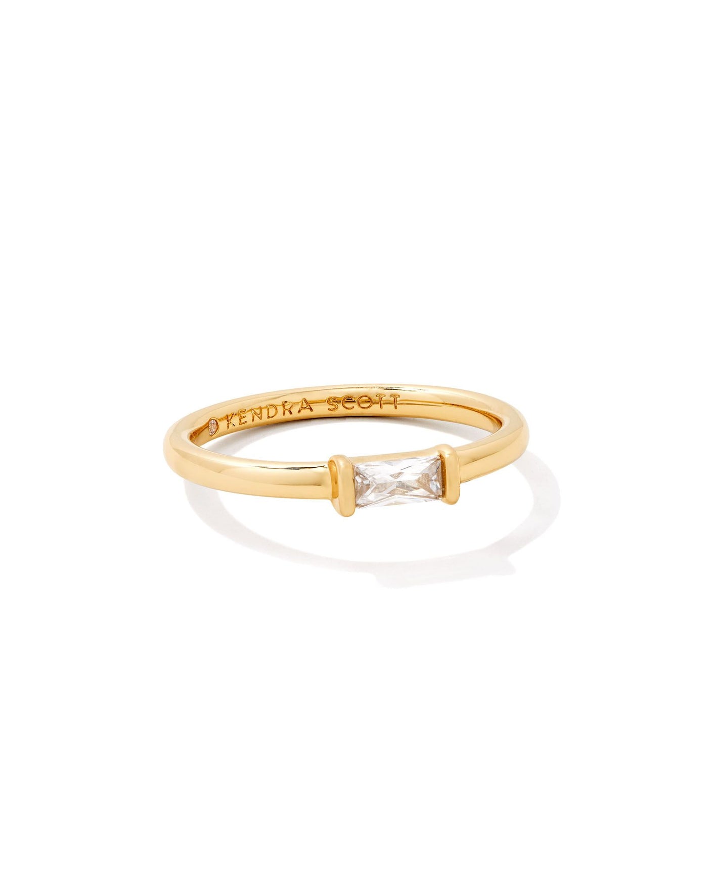 Gold ring with white crystal baguette stone.