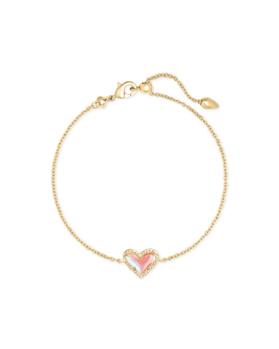 Gold clasp bracelet with dichroic glass heart pendant. 