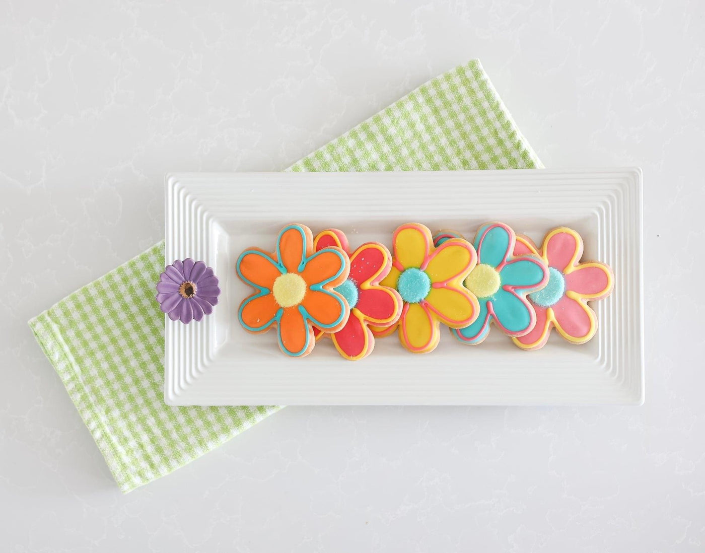 Purple flower with gold center mini on a white tray 