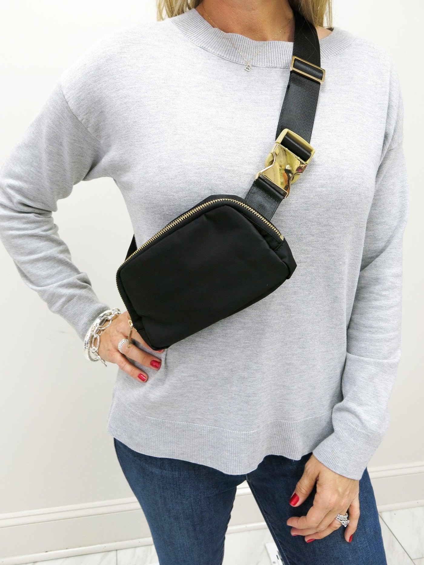 Black Belt Bag worn as a crossbody across the chest.