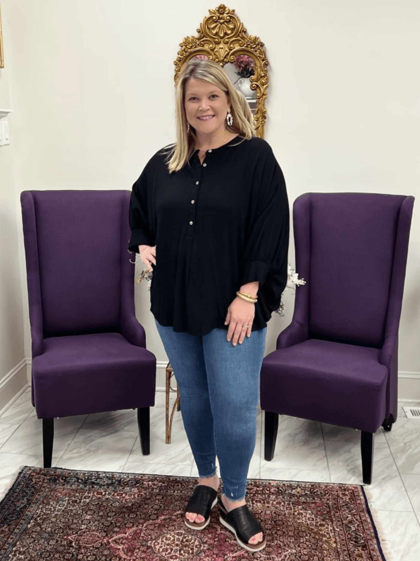 Black button down dolman top styled with blue jeans and black wedges on a curvy model