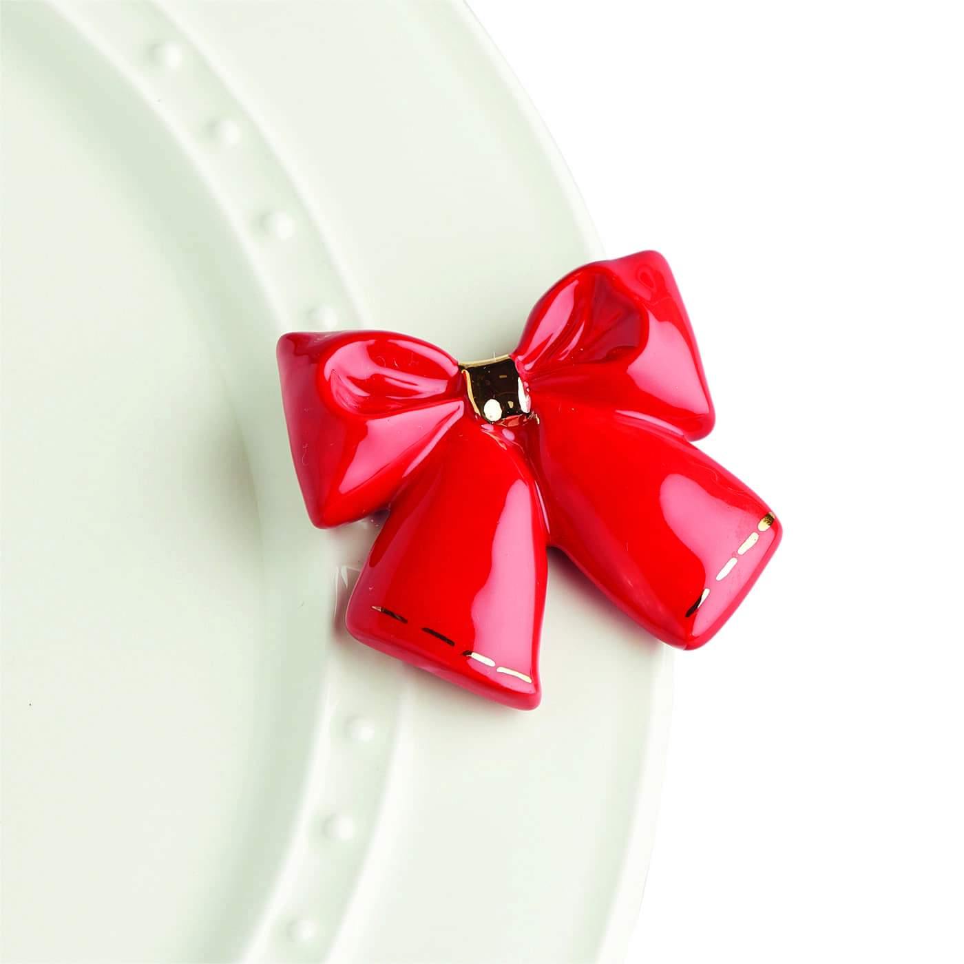 Red bow with gold trim for decorating a Nora Fleming dish